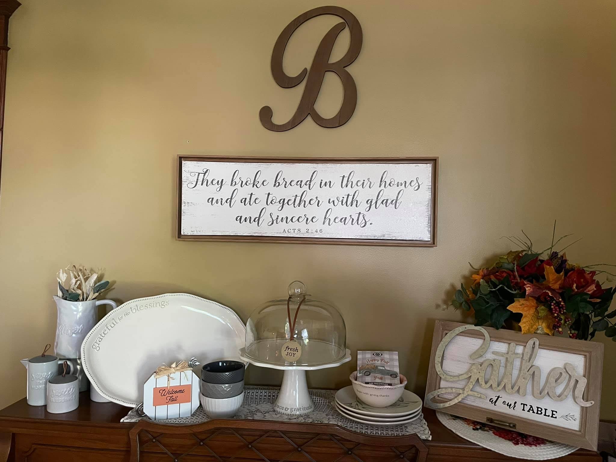 “A Quiet Gathering: A well-arranged display of faith-inspired items, including plates, mugs, and a framed quote.”
